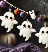 A felt wool Halloween garland featuring charming handmade ghost and bat decorations, perfect for Halloween decor.